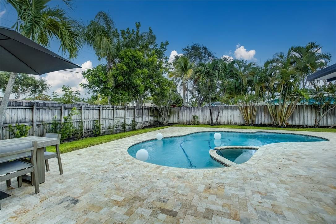 4117 McKinley Street Hollywood, FL 33021 - Photo 50 of 52 a view of backyard with swimming pool and outdoor seating