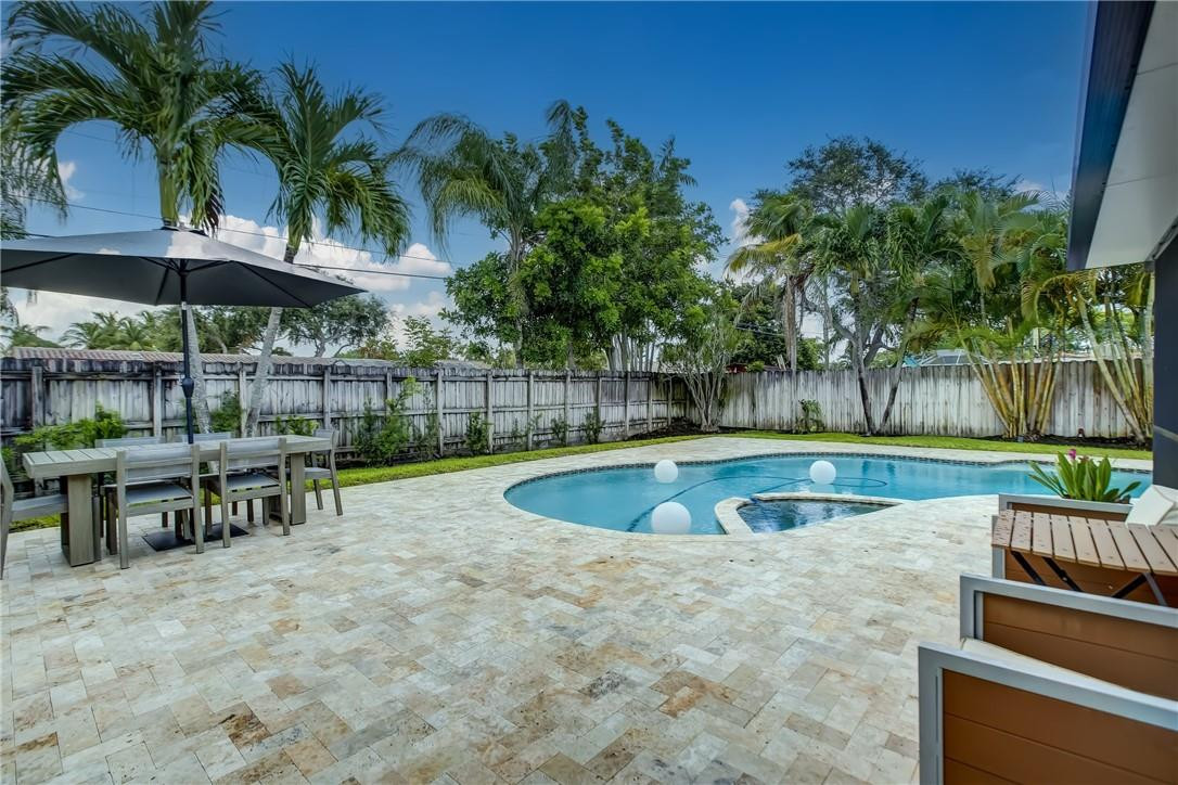 4117 McKinley Street Hollywood, FL 33021 - Photo 52 of 52 a view of a backyard with a swimming pool and sitting area