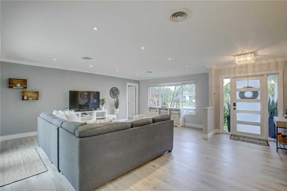 4117 McKinley Street Hollywood, FL 33021 - Photo 8 of 52 a living room with furniture a flat screen tv and wooden floor
