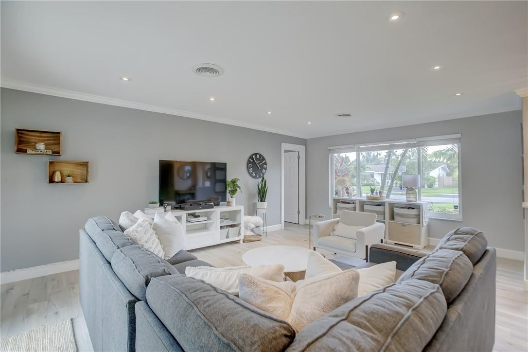 4117 McKinley Street Hollywood, FL 33021 - Photo 9 of 52 a living room with furniture flat screen tv and a large window