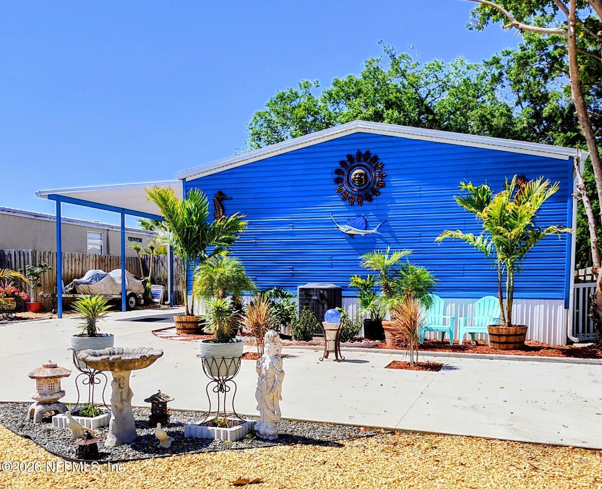 137 Lewis Street Edgewater, FL 32141 - Photo 1 of 42 a view of a backyard with plants and a patio