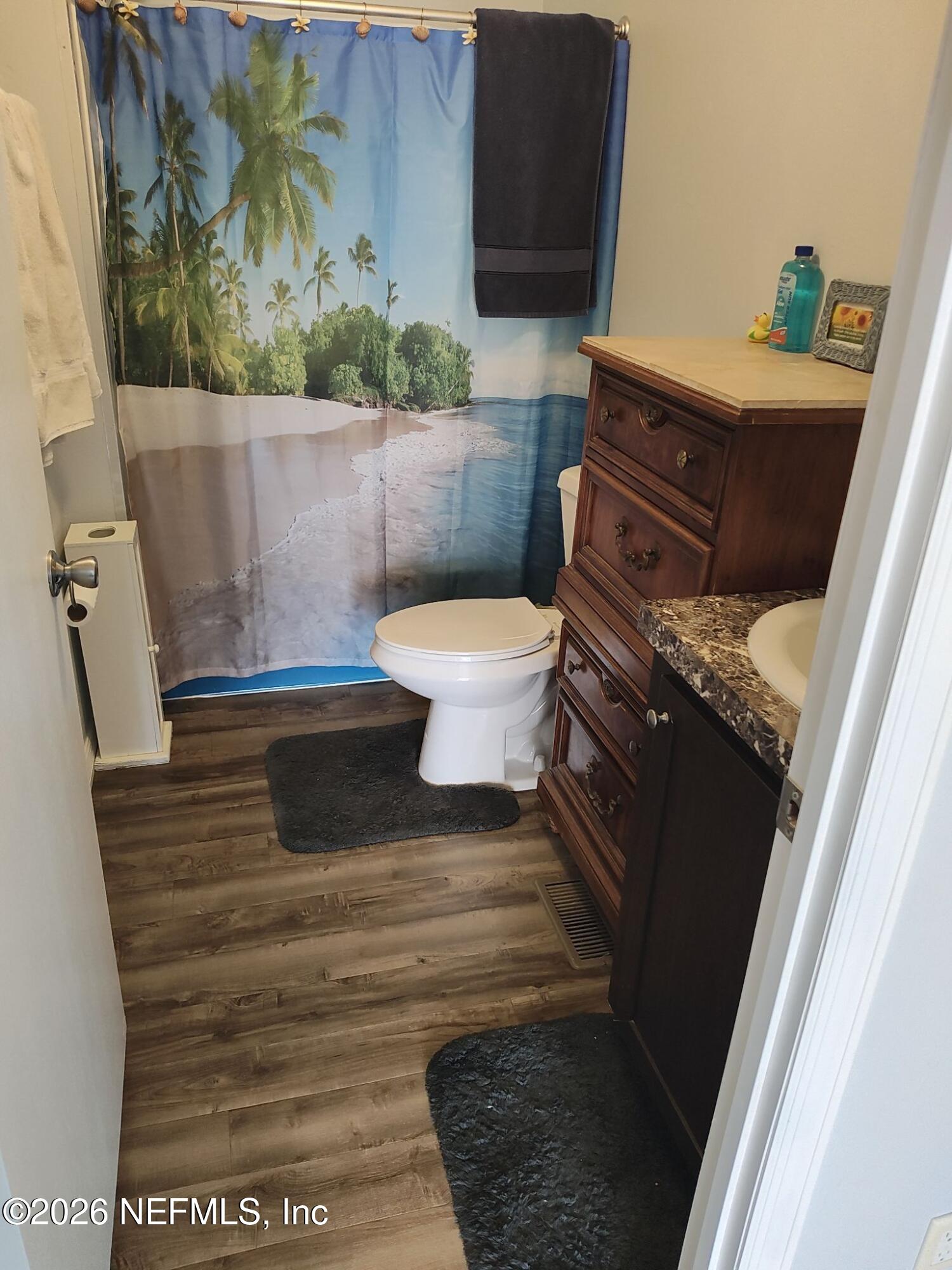 137 Lewis Street Edgewater, FL 32141 - Photo 12 of 42 a bathroom with a toilet and a shower