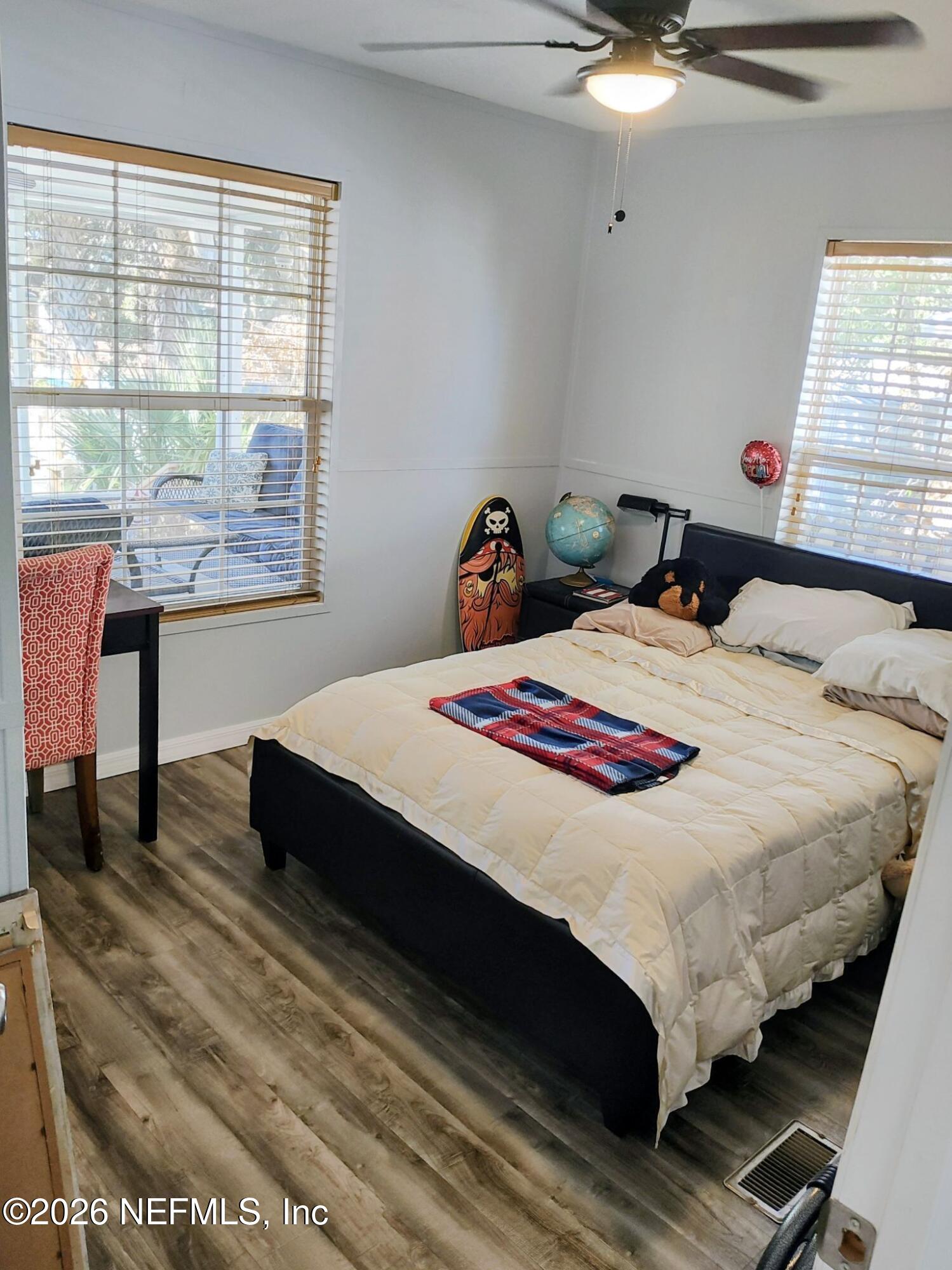 137 Lewis Street Edgewater, FL 32141 - Photo 14 of 42 a bedroom with bed and window