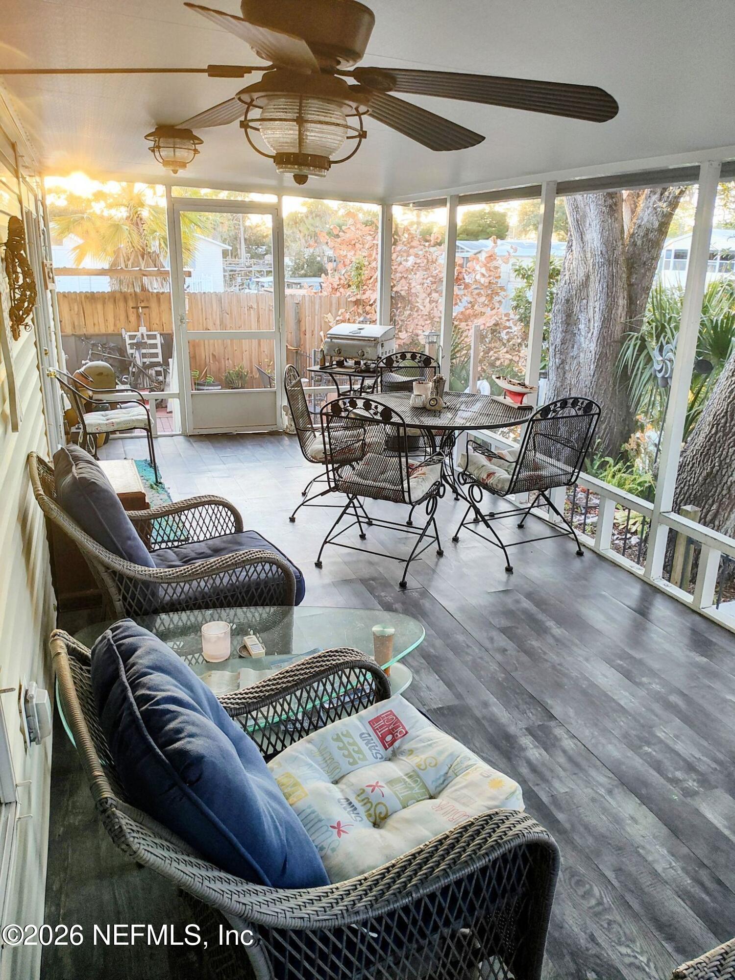 137 Lewis Street Edgewater, FL 32141 - Photo 22 of 42 a living room with furniture and a floor to ceiling window