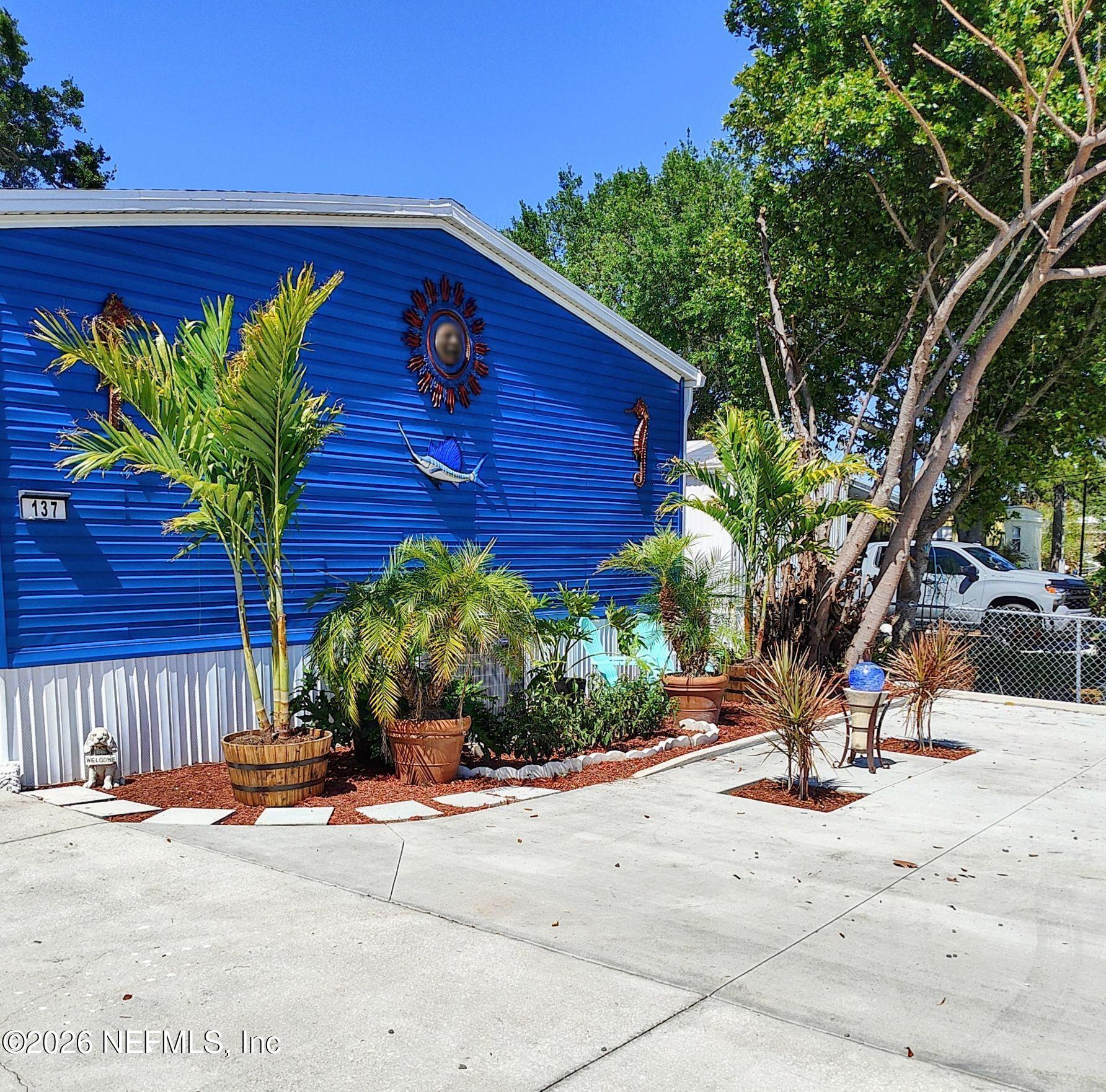 137 Lewis Street Edgewater, FL 32141 - Photo 37 of 42 a view of a house with a yard and potted plants