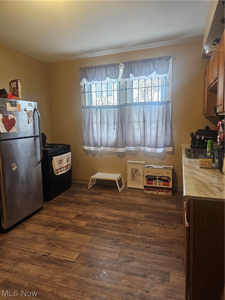 4324 Turney Road Cleveland, OH 44105 - Photo 17 of 27 Kitchen with refrigerator, dark hardwood / wood-style floors, sink, and stove