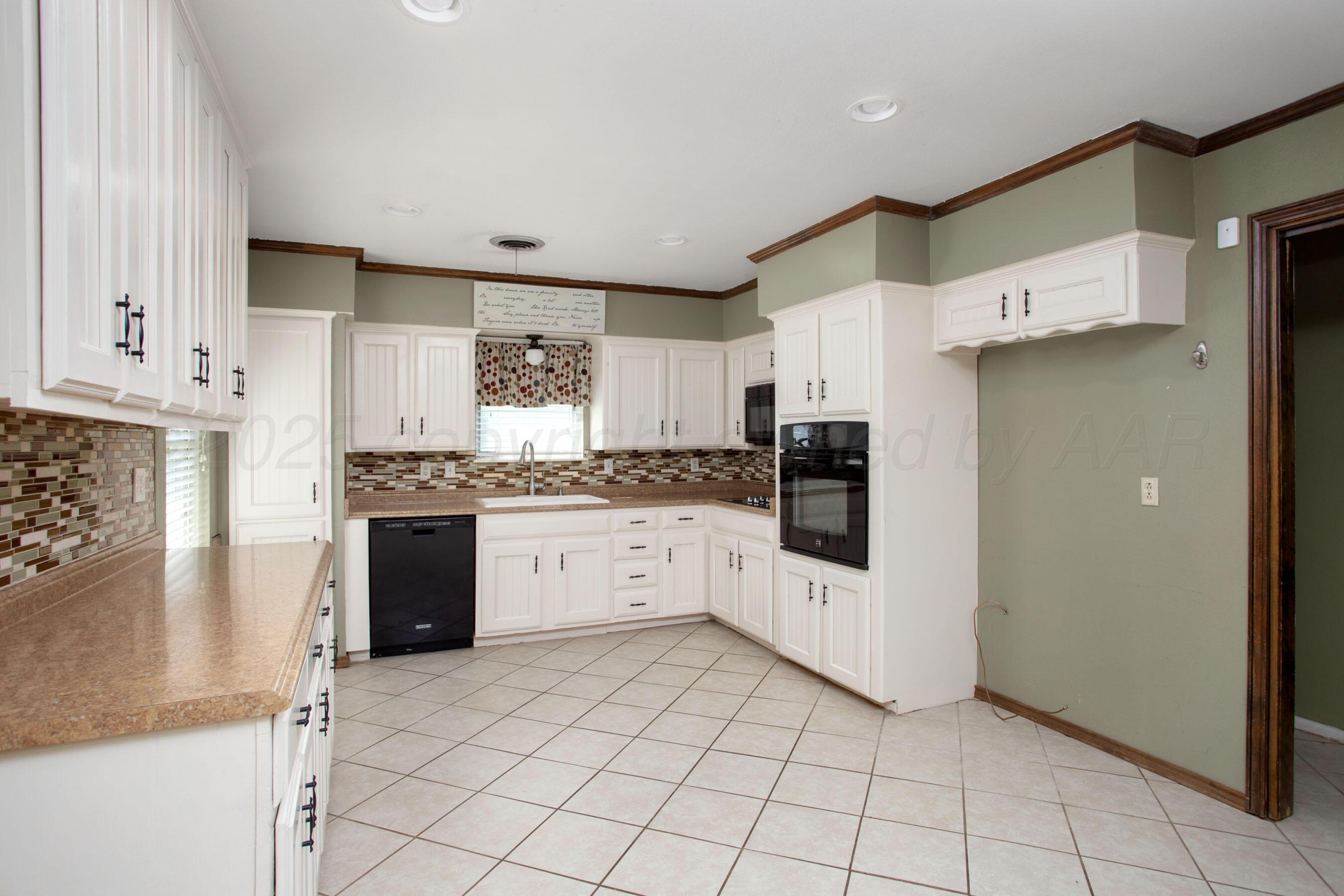 3729 Wayne Street Amarillo, TX 79109 - Photo 13 of 30 a kitchen with stainless steel appliances a refrigerator sink and cabinets