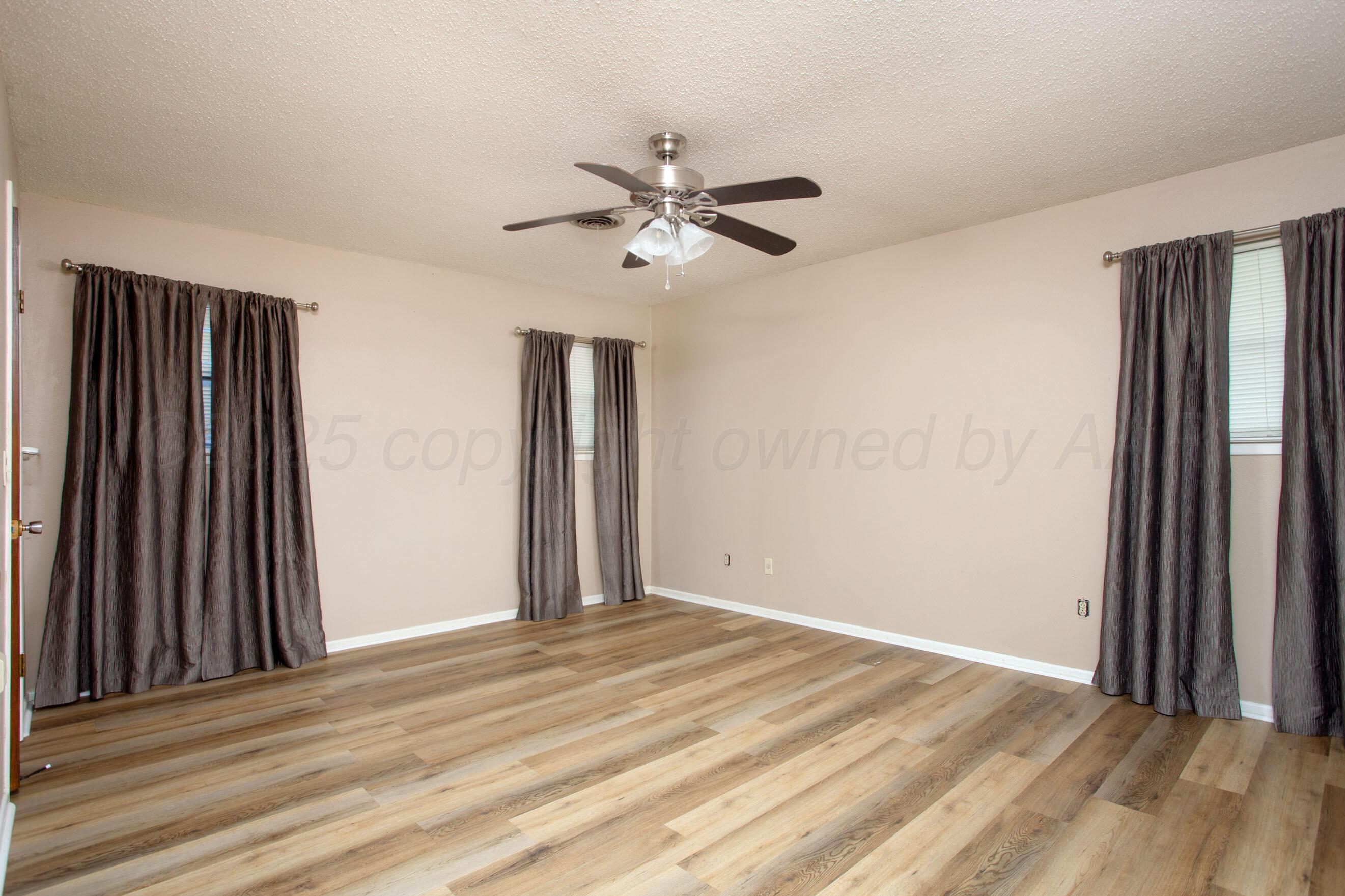 3729 Wayne Street Amarillo, TX 79109 - Photo 16 of 30 wooden floor in an empty room with a window