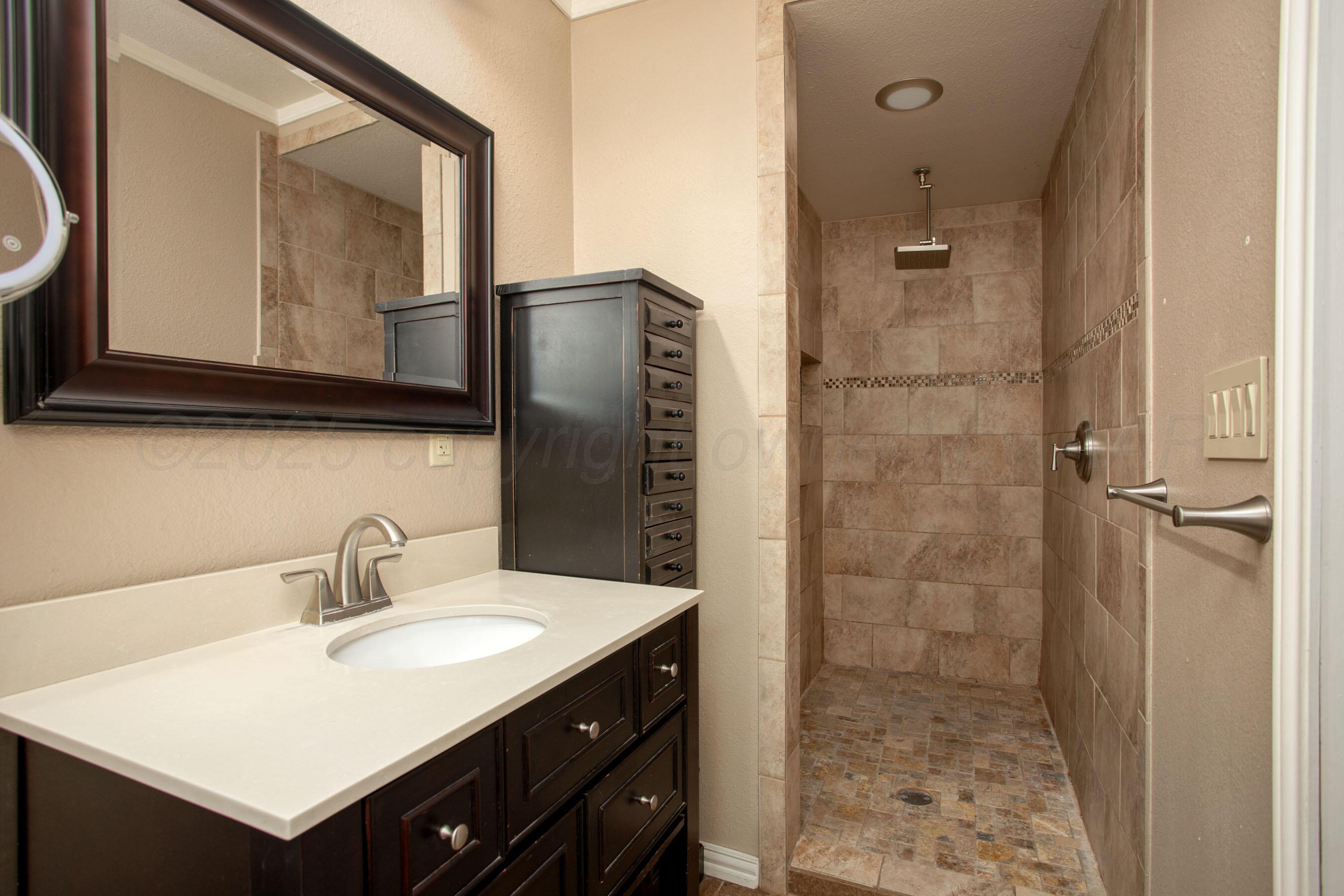 3729 Wayne Street Amarillo, TX 79109 - Photo 18 of 30 a bathroom with a sink vanity and a mirror