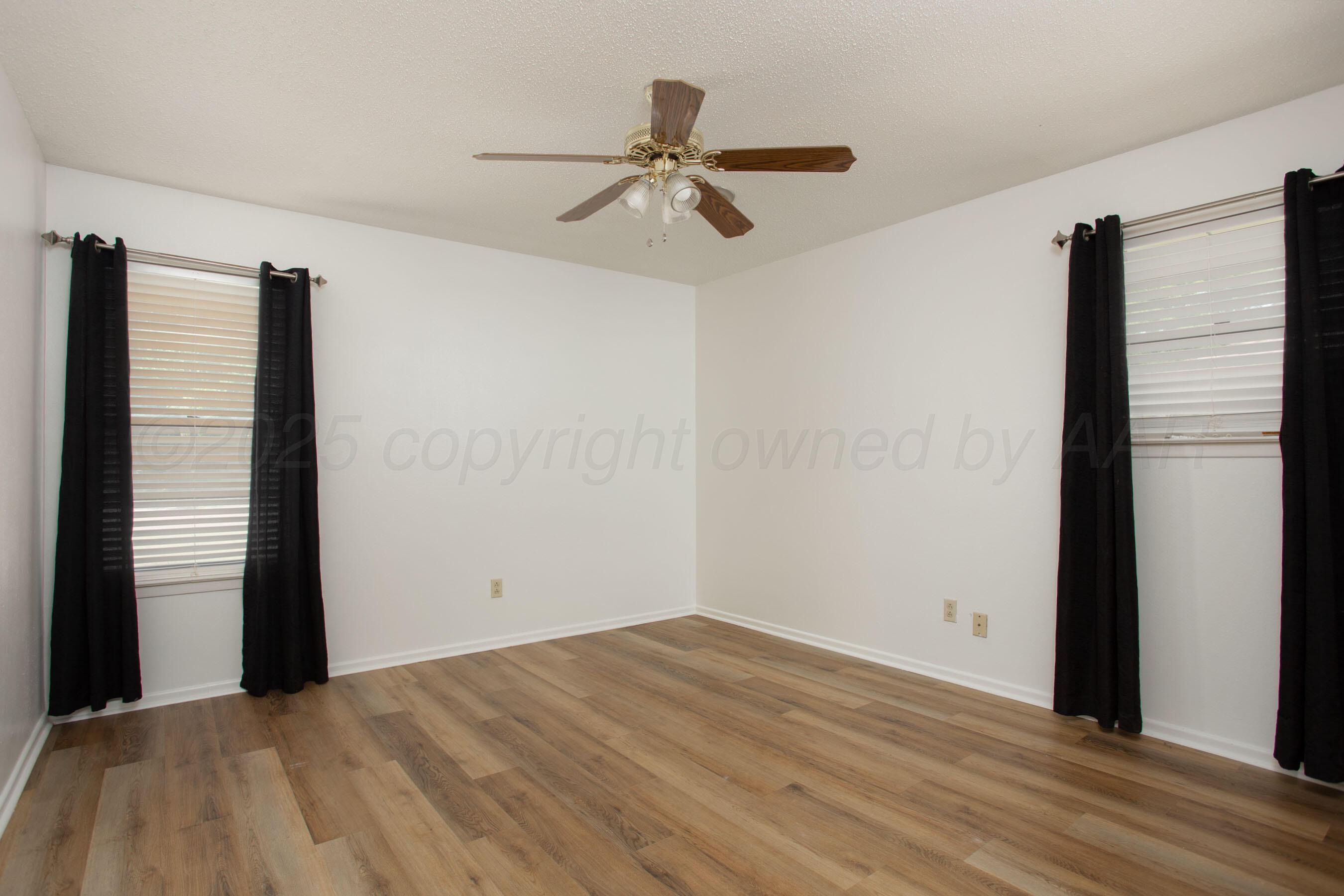 3729 Wayne Street Amarillo, TX 79109 - Photo 20 of 30 a view of empty room with wooden floor and fan