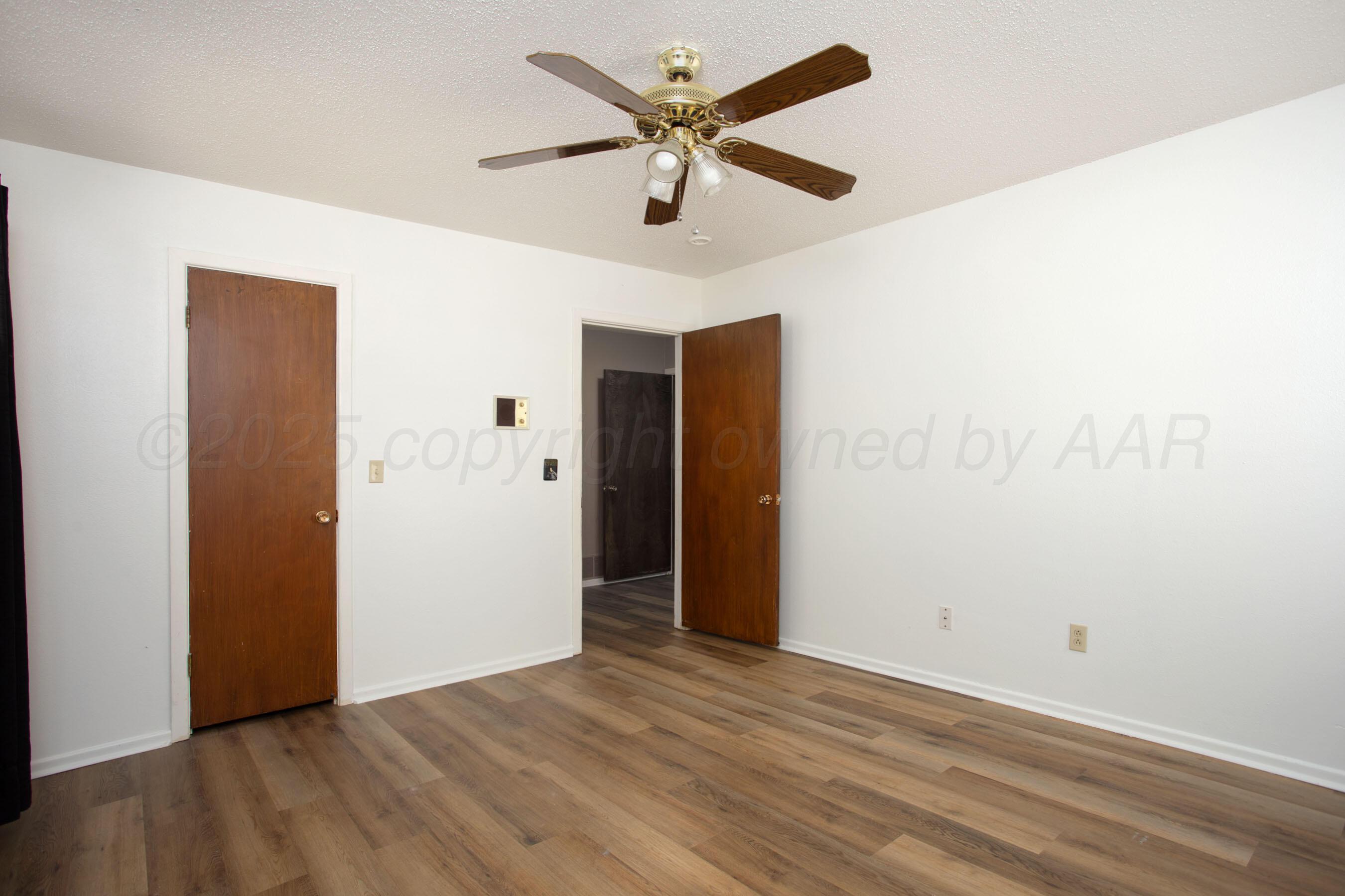 3729 Wayne Street Amarillo, TX 79109 - Photo 21 of 30 an empty room with closet and a ceiling fan