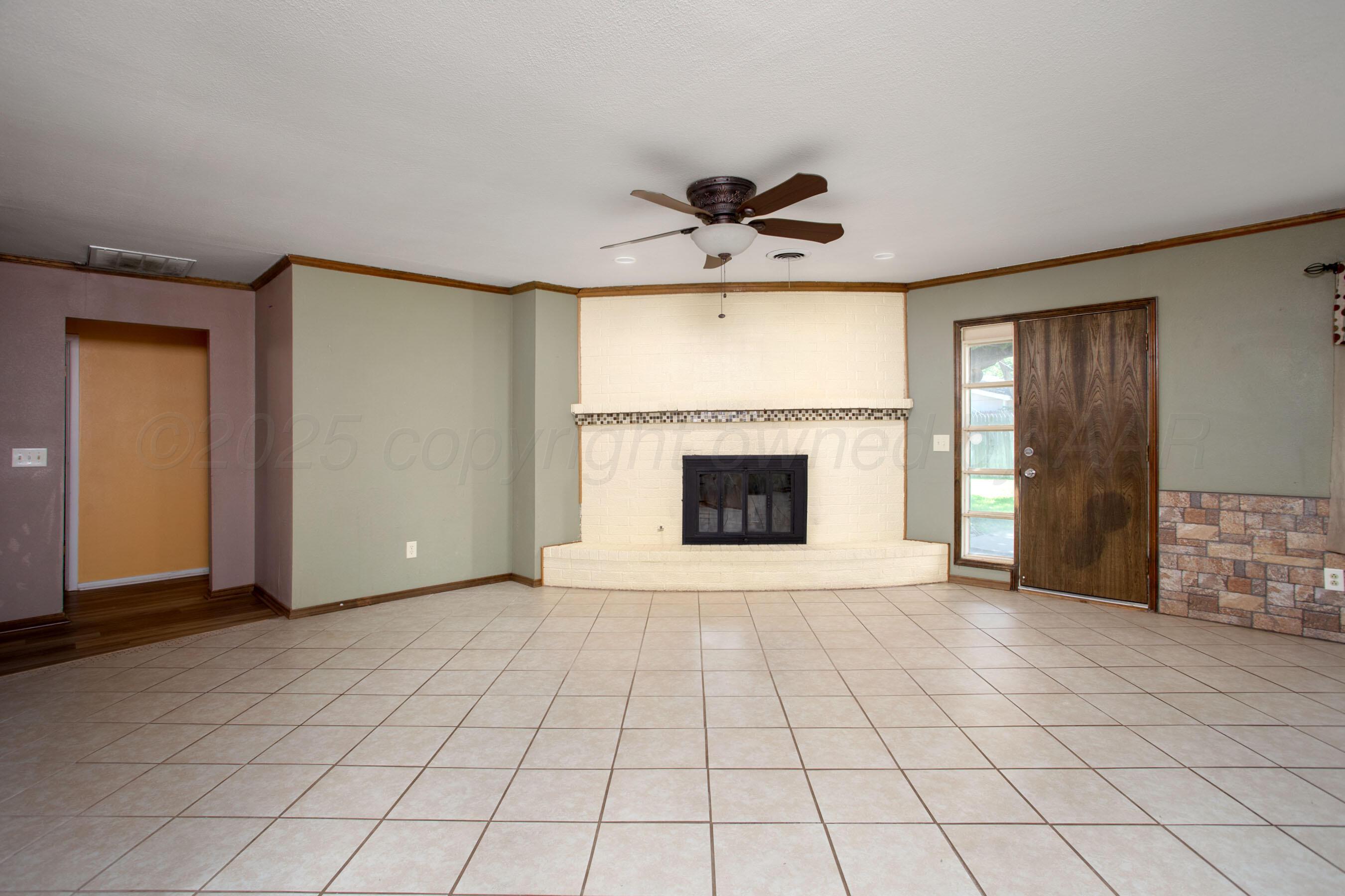 3729 Wayne Street Amarillo, TX 79109 - Photo 8 of 30 a view of an empty room with a fireplace