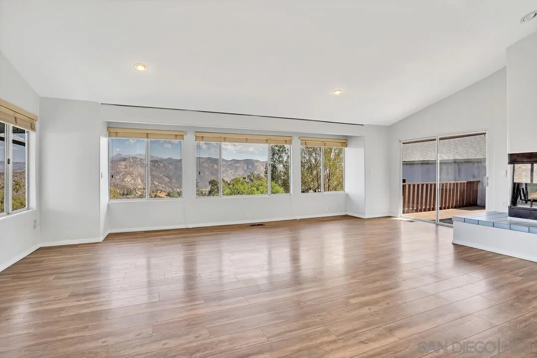 12040 Rocoso Road Lakeside, CA 92040 - Photo 2 of 56 a view of an empty room with wooden floor and a window