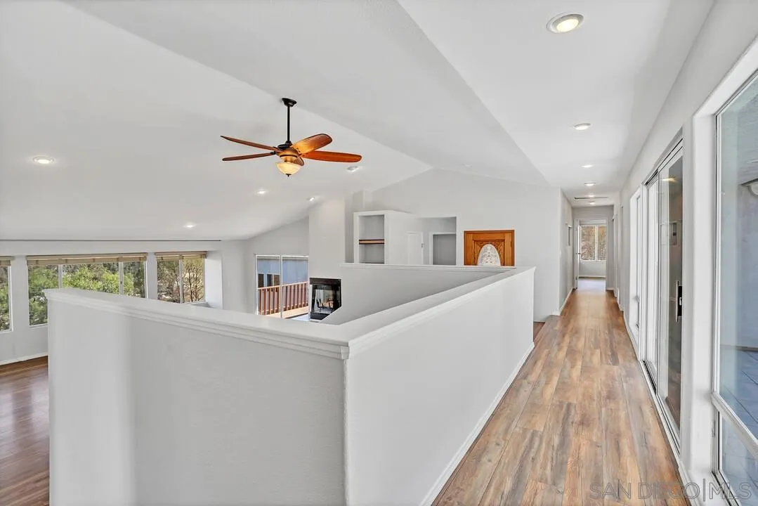 12040 Rocoso Road Lakeside, CA 92040 - Photo 23 of 56 a view of a hallway with a window and wooden floor