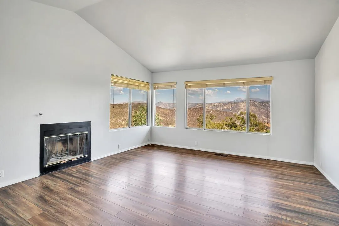 12040 Rocoso Road Lakeside, CA 92040 - Photo 24 of 56 wooden floor fireplace and windows in a room