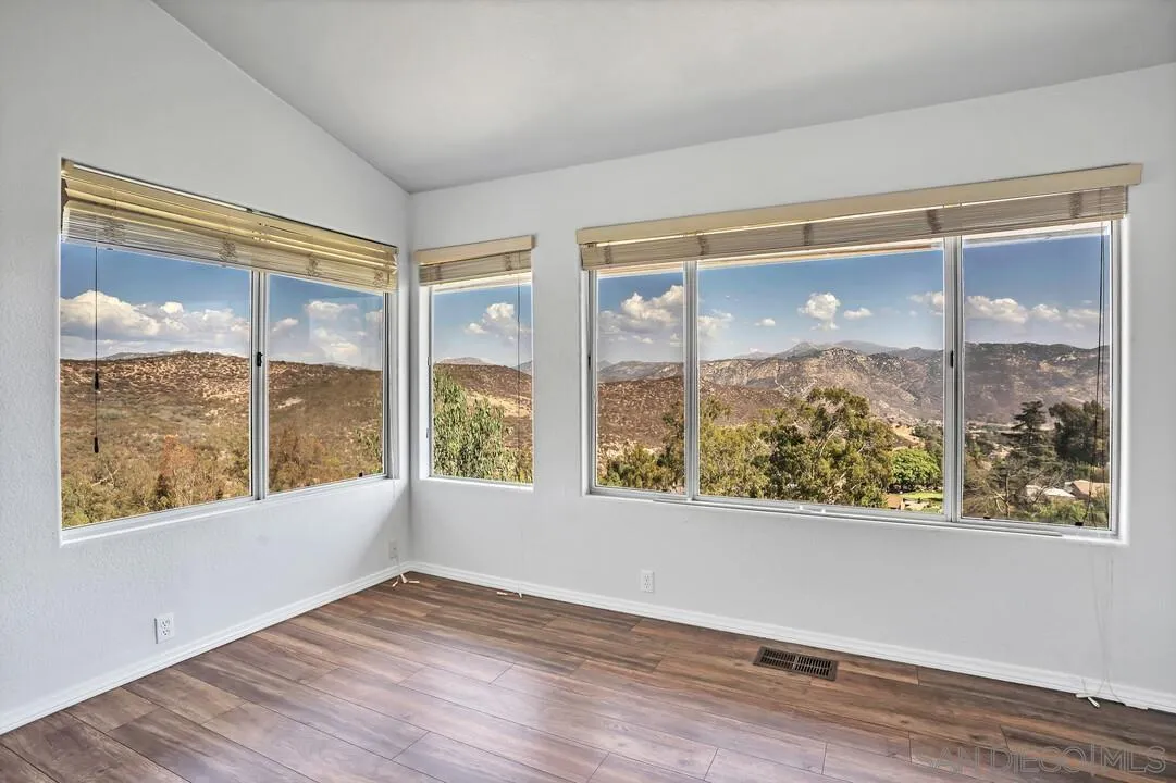 12040 Rocoso Road Lakeside, CA 92040 - Photo 25 of 56 a view of an empty room with wooden floor and a window