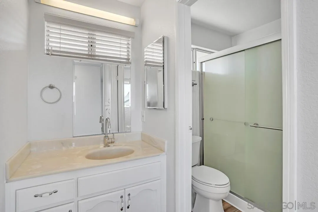 12040 Rocoso Road Lakeside, CA 92040 - Photo 27 of 56 a bathroom with a sink toilet a mirror and shower