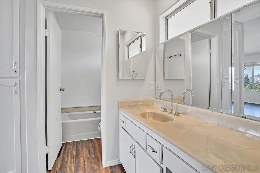 12040 Rocoso Road Lakeside, CA 92040 - Photo 29 of 56 a bathroom with a sink a vanity and a mirror
