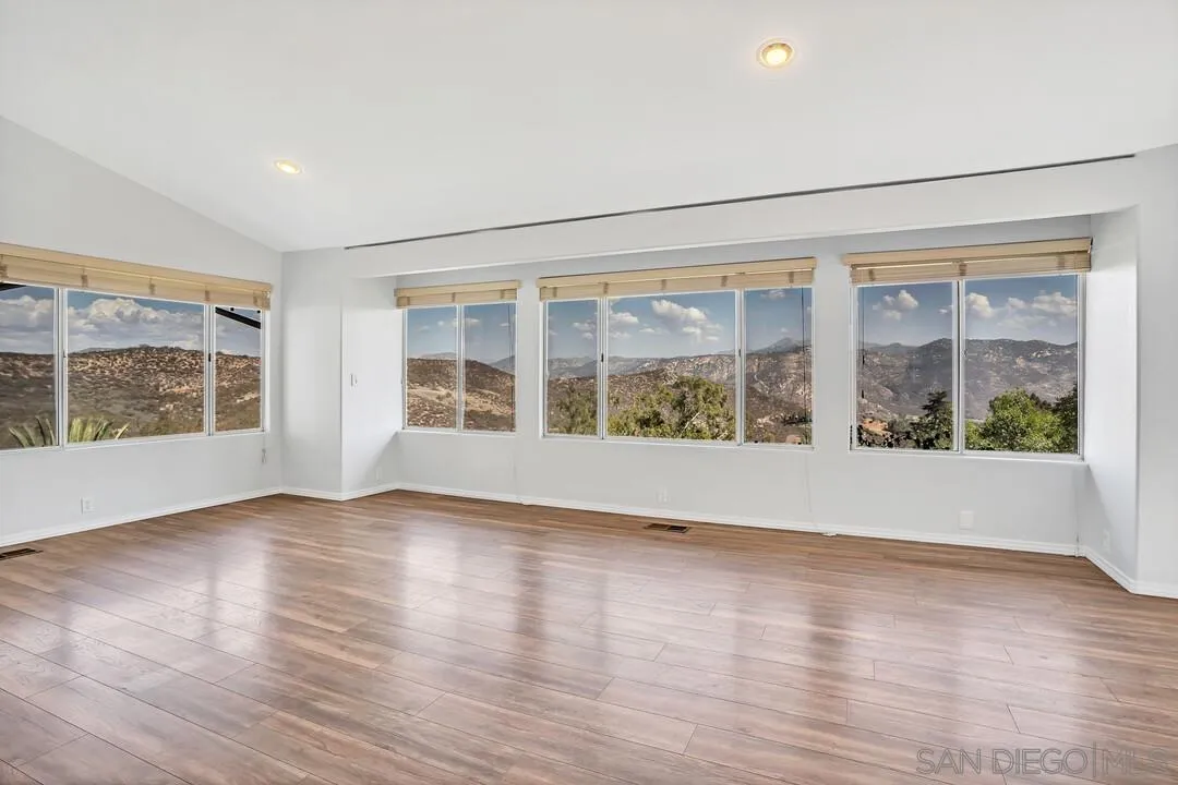 12040 Rocoso Road Lakeside, CA 92040 - Photo 3 of 56 a view of an empty room with wooden floor and a window