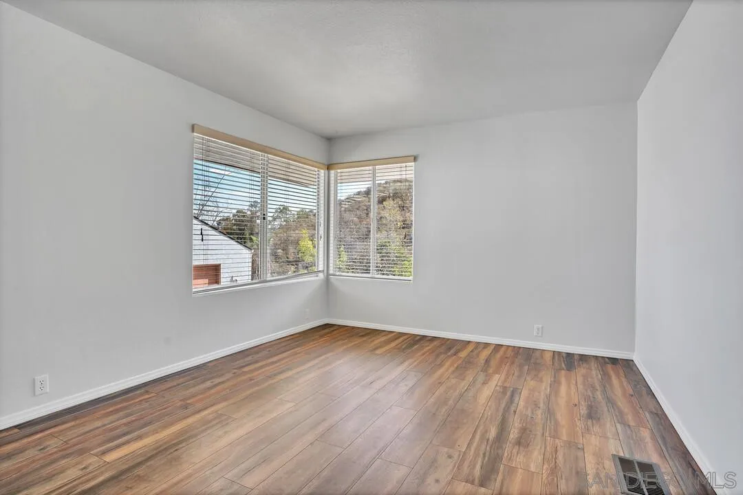 12040 Rocoso Road Lakeside, CA 92040 - Photo 36 of 56 wooden floor in an empty room with a window