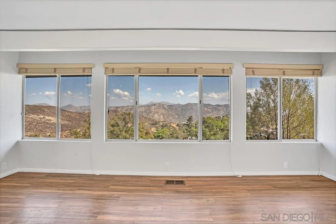 12040 Rocoso Road Lakeside, CA 92040 - Photo 4 of 56 a view of an empty room with wooden floor and a window