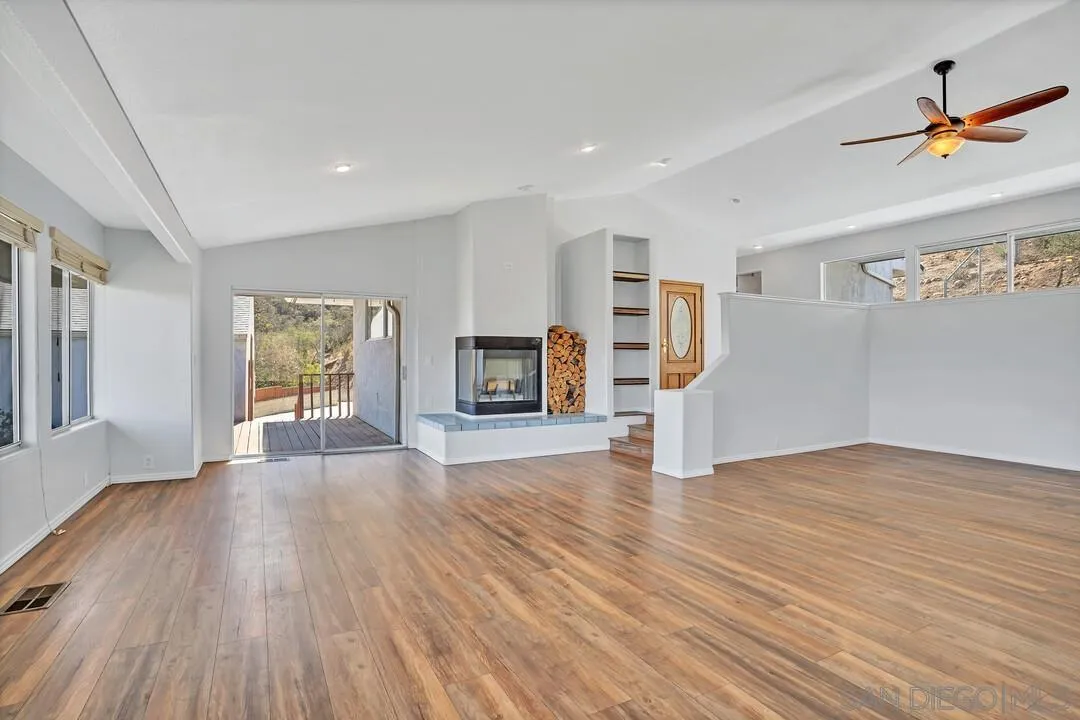 12040 Rocoso Road Lakeside, CA 92040 - Photo 5 of 56 a view of an empty room with wooden floor and a window