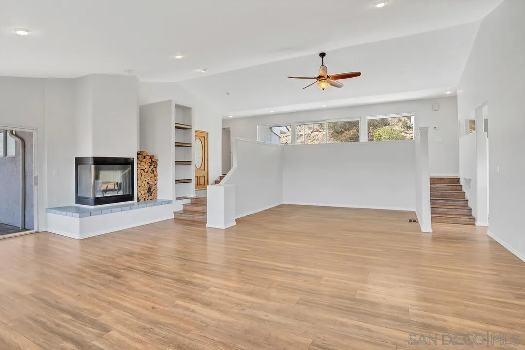 12040 Rocoso Road Lakeside, CA 92040 - Photo 6 of 56 a view of a livingroom with wooden floor and a ceiling fan
