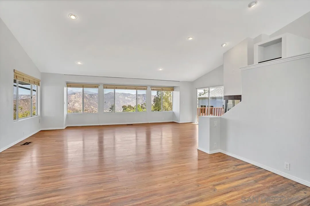 12040 Rocoso Road Lakeside, CA 92040 - Photo 9 of 56 an empty room with wooden floor and windows