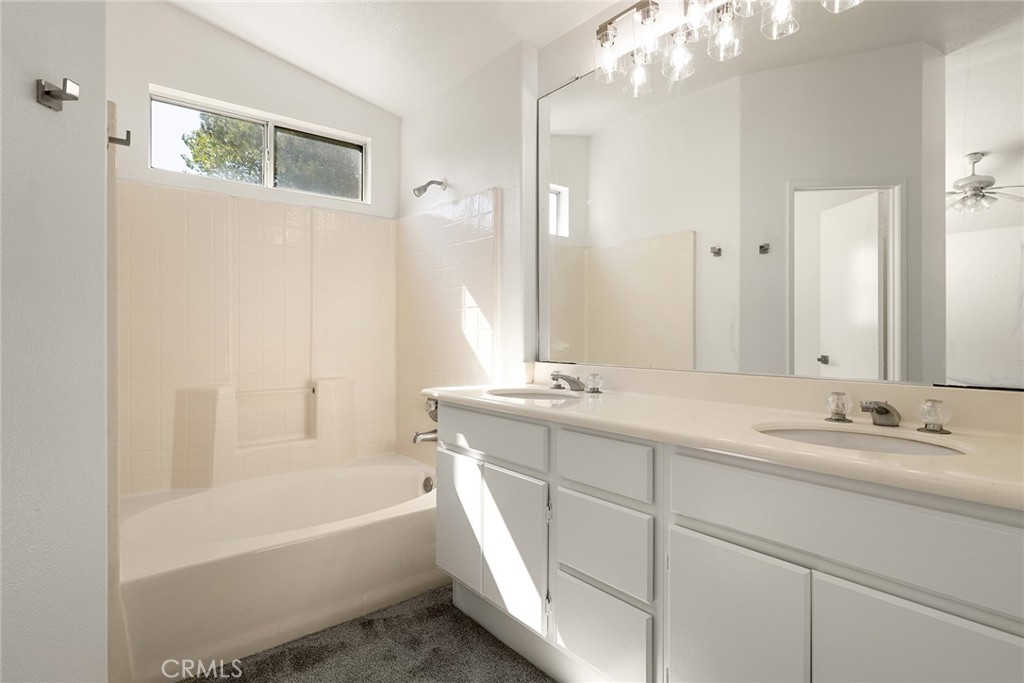 6011 Matheson Drive Riverside, CA 92507 - Photo 6 of 10 a bathroom with a tub a sink and mirror