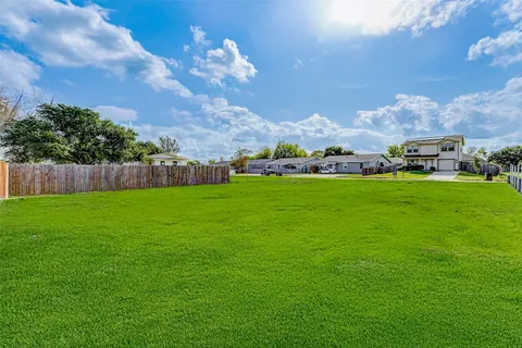 a view of yard with swimming pool and green space