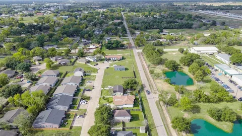 an aerial view of a residential houses with outdoor space