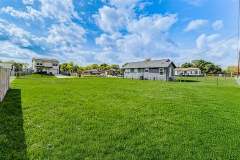 a view of a big yard with a house in the background