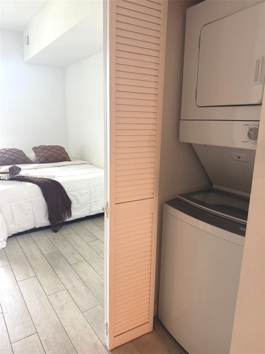 321 Northeast 26th Street, Unit 701 Miami, FL 33137 - Photo 11 of 12 a bedroom with a bed and a cabinets