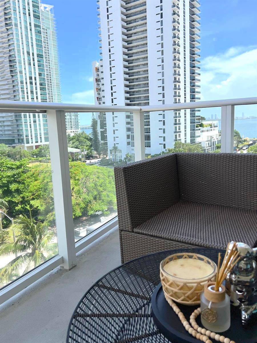 321 Northeast 26th Street, Unit 701 Miami, FL 33137 - Photo 4 of 12 a view of a balcony with chair and wooden floor