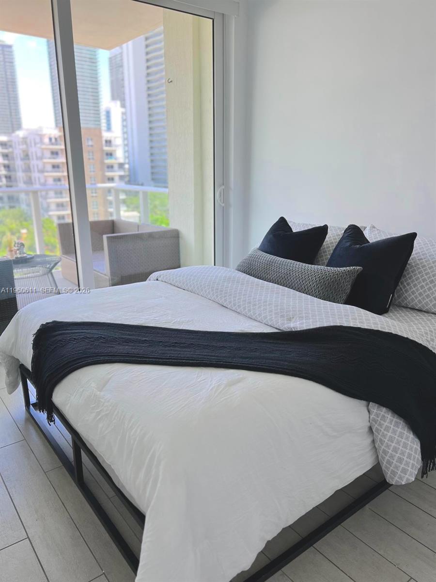 321 Northeast 26th Street, Unit 701 Miami, FL 33137 - Photo 5 of 12 a bedroom with a bed and wooden floor