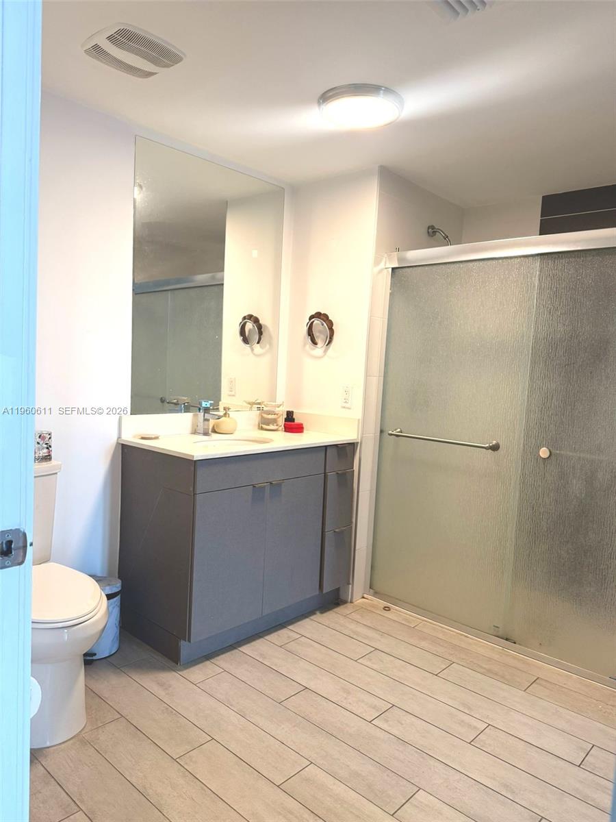 321 Northeast 26th Street, Unit 701 Miami, FL 33137 - Photo 6 of 12 a bathroom with a sink a toilet and shower
