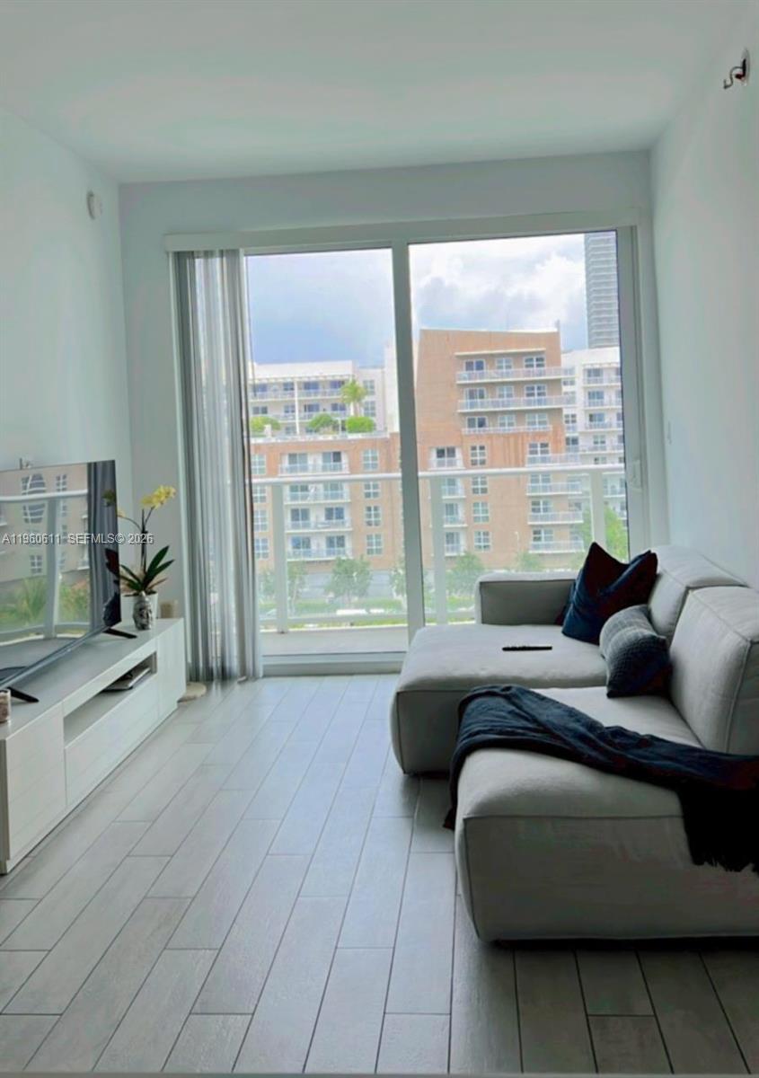 321 Northeast 26th Street, Unit 701 Miami, FL 33137 - Photo 8 of 12 a living room with furniture and a large window