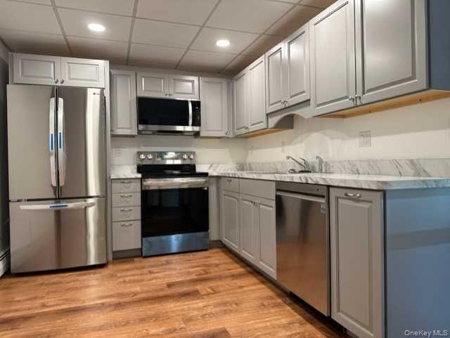7 High Acres Drive, Unit 1 Poughkeepsie, NY 12603 - Photo 1 of 1 a kitchen with stainless steel appliances granite countertop a refrigerator stove a sink and a microwave