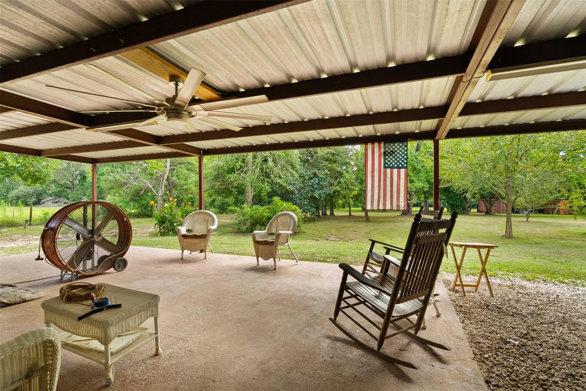 a view of a patio with a table chairs and a backyard