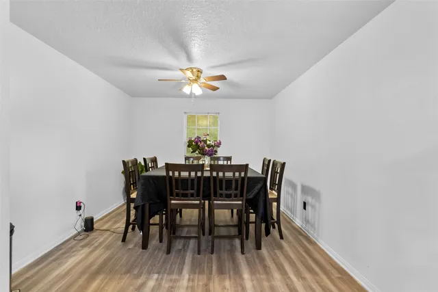 a view of a dining room with furniture and chandelier