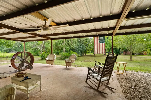 a view of a patio with a table chairs and a backyard