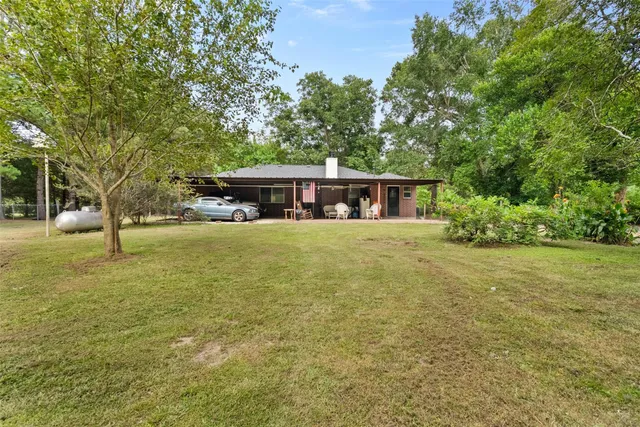 a view of a swimming pool and trees in the background
