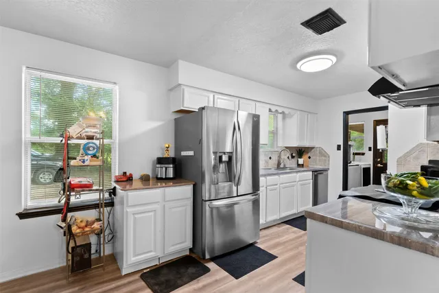 a kitchen with a sink a counter top space and stainless steel appliances