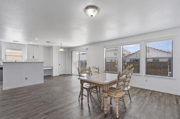 a dining room with furniture and wooden floor