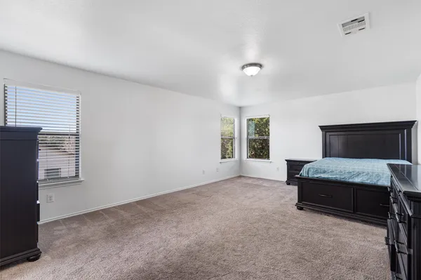 a living room with furniture and a dresser