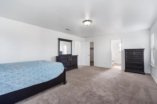 a bedroom with a bed and a cabinets