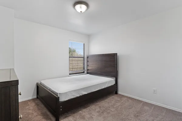 a bedroom with a bed and a bathroom