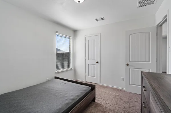 a room with a bed and a window
