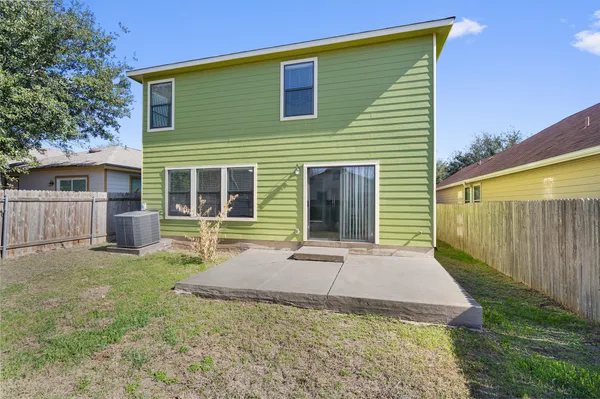 a view of a house with backyard and porch