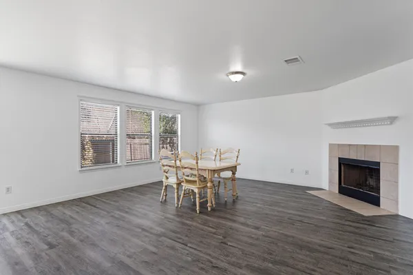 a dining room with furniture wooden floor and a fireplace